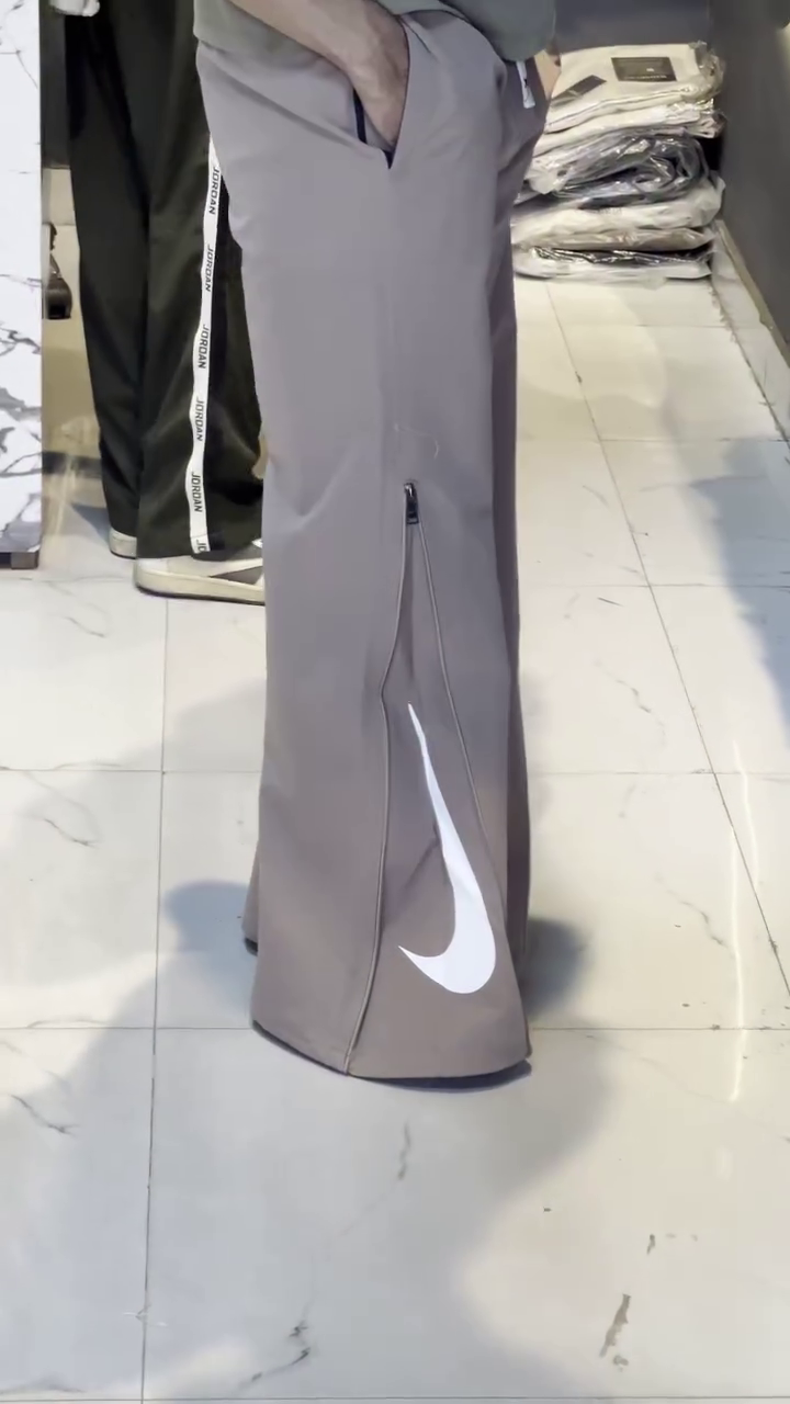 Premium Taupe Athletic Wide-Leg Track Pants with Side Zip Detail and Large White Swoosh Branding 🤍