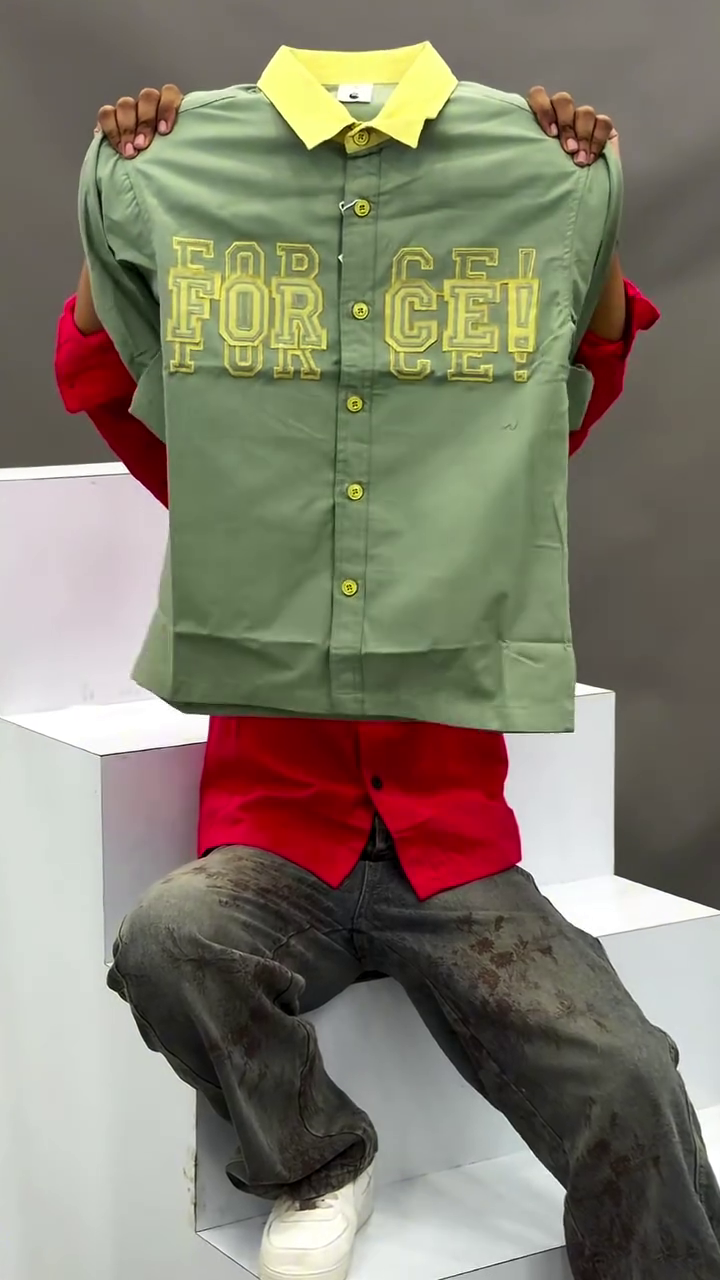 Men's Vibrant Red Button-Down Casual Shirt Featuring Contrasting Black Lapel Collar, Bold Typographic Chest Embroidery, and Distressed Wash Denim Pants