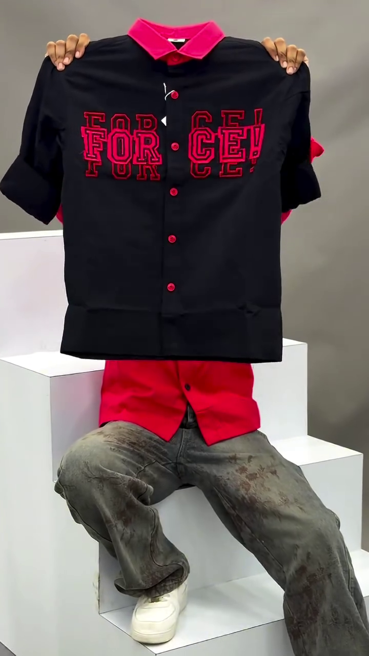 Men's Vibrant Red Button-Down Casual Shirt Featuring Contrasting Black Lapel Collar, Bold Typographic Chest Embroidery, and Distressed Wash Denim Pants