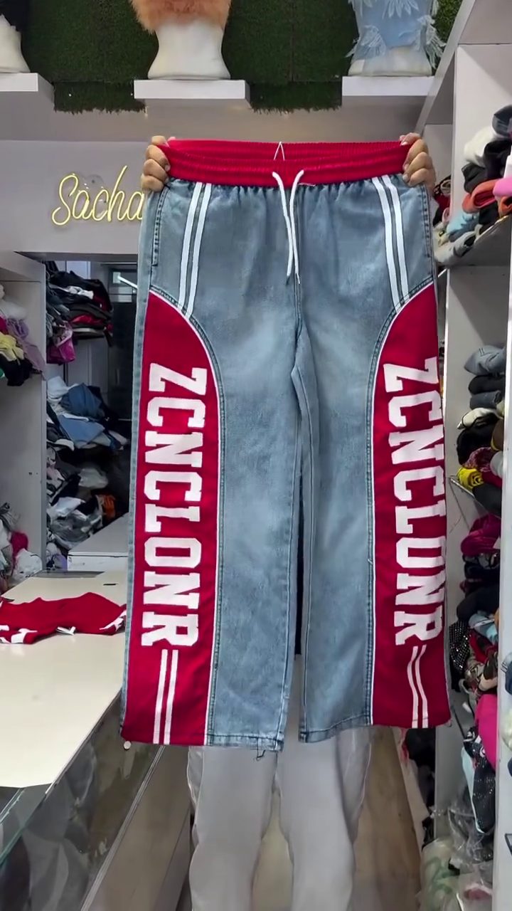 Vibrant Red Crop Top with Number "76" Athletic Print Paired with Light-Wash Denim Pants Featuring Bold Red Side Stripe Panels and Typographic Lettering