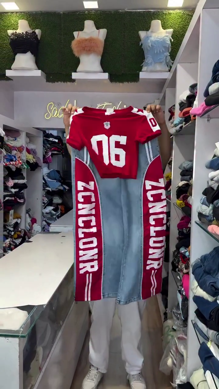 Vibrant Red Crop Top with Number "76" Athletic Print Paired with Light-Wash Denim Pants Featuring Bold Red Side Stripe Panels and Typographic Lettering