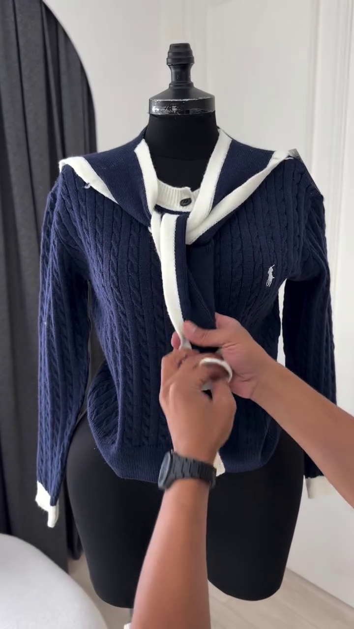 Classic Off-White Cable-Knit Cardigan Featuring a V-Neckline, Front Button Closure, and Contrasting Detachable Black Accent Panels