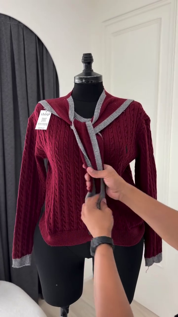 Classic Off-White Cable-Knit Cardigan Featuring a V-Neckline, Front Button Closure, and Contrasting Detachable Black Accent Panels
