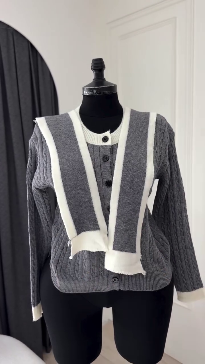 Classic Off-White Cable-Knit Cardigan Featuring a V-Neckline, Front Button Closure, and Contrasting Detachable Black Accent Panels