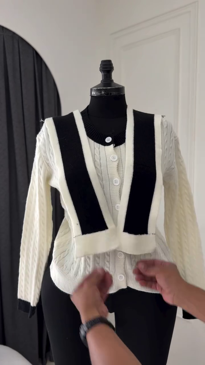 Classic Off-White Cable-Knit Cardigan Featuring a V-Neckline, Front Button Closure, and Contrasting Detachable Black Accent Panels